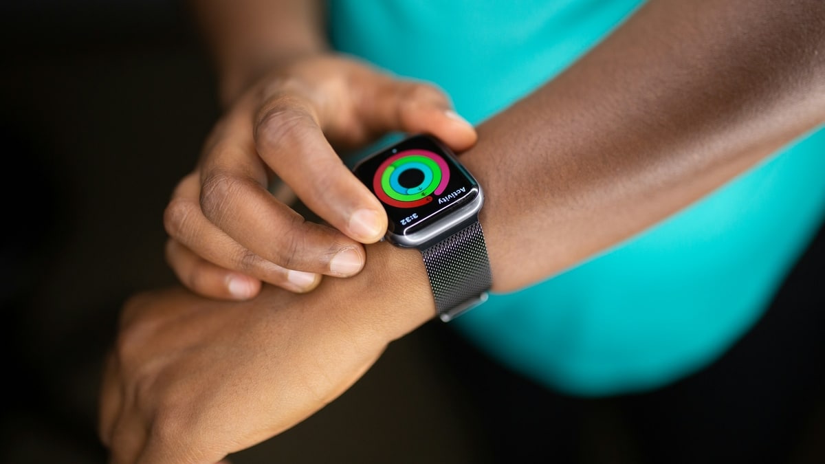 A person wears a smart watch and checks their activity
