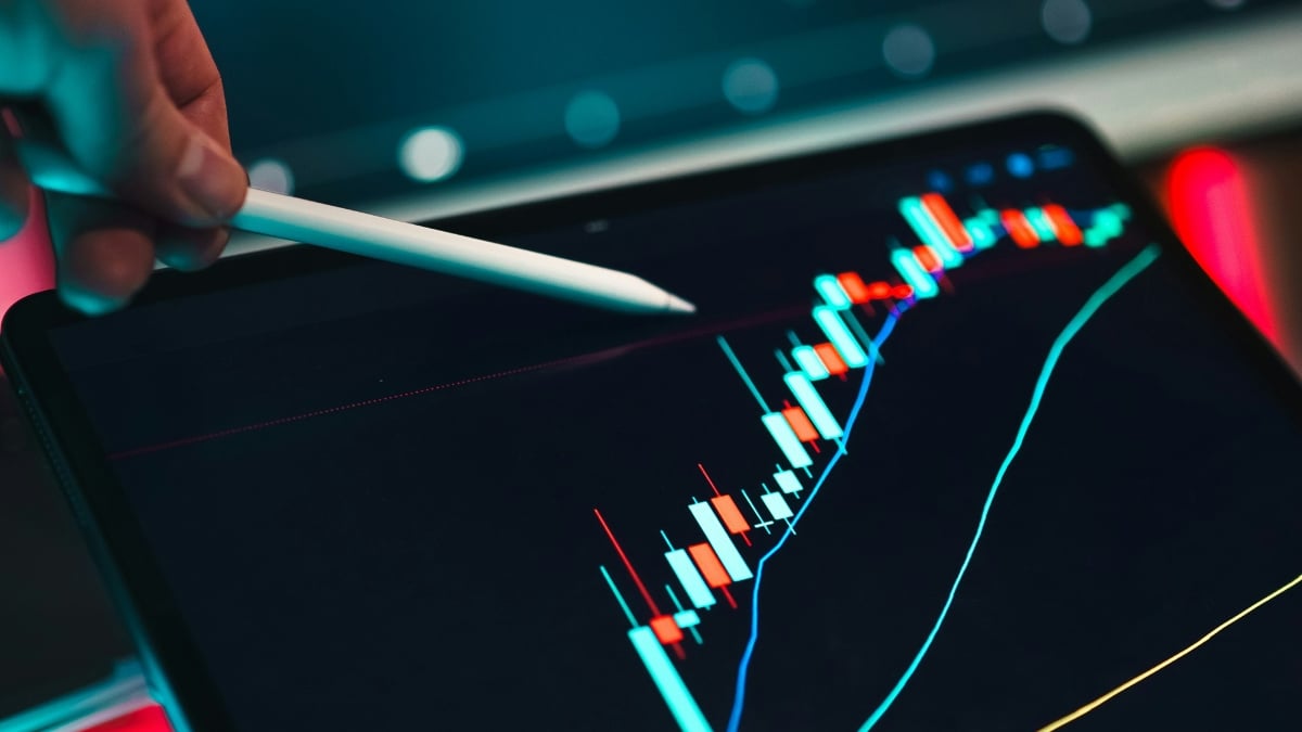A person using a laptop at a desk for financial analysis