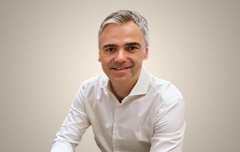 Chairman Mike Flache in front of a studio background