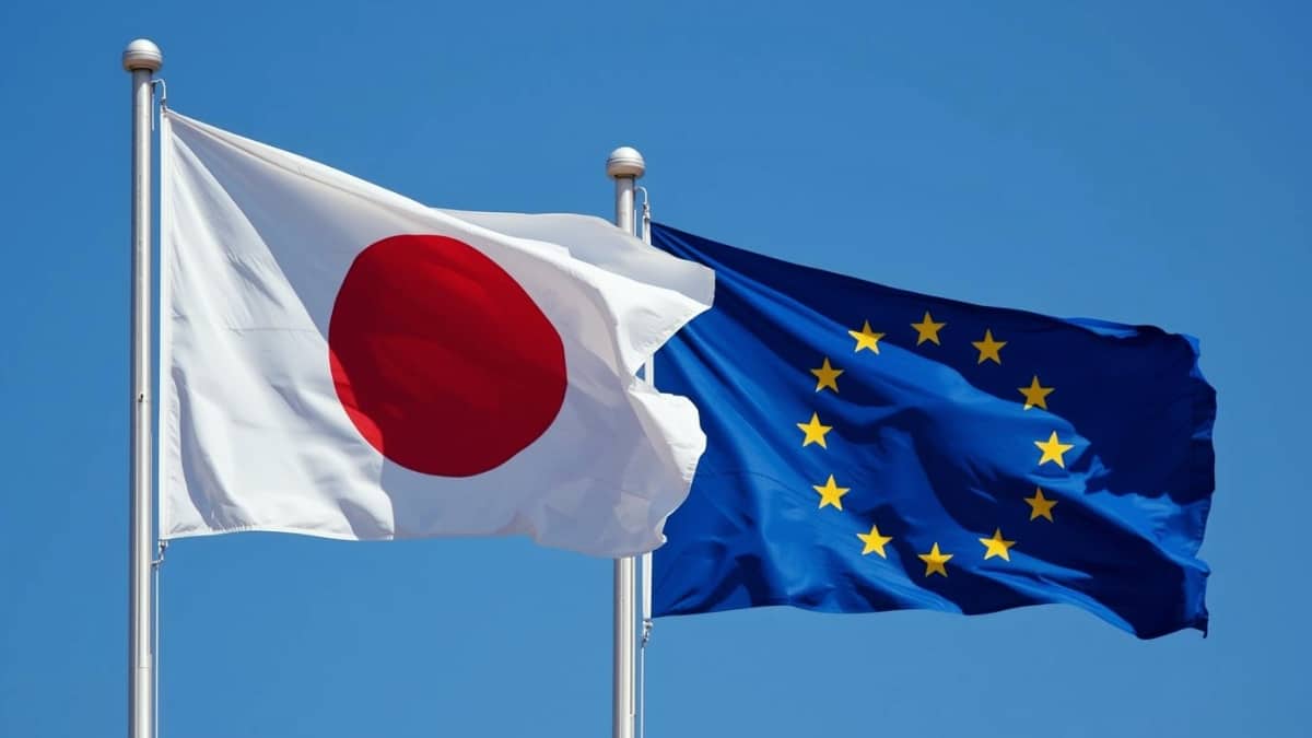 Japan flag and European Union flag in front of a blue sky