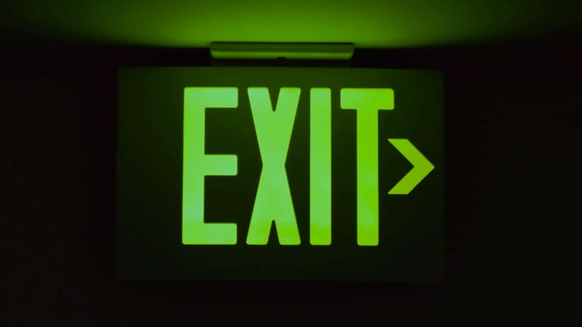 An illuminated exit sign points the way out